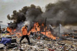 Petugas BPBD melintasi yang masih menyala di TPA Saribukti Bandung Barat